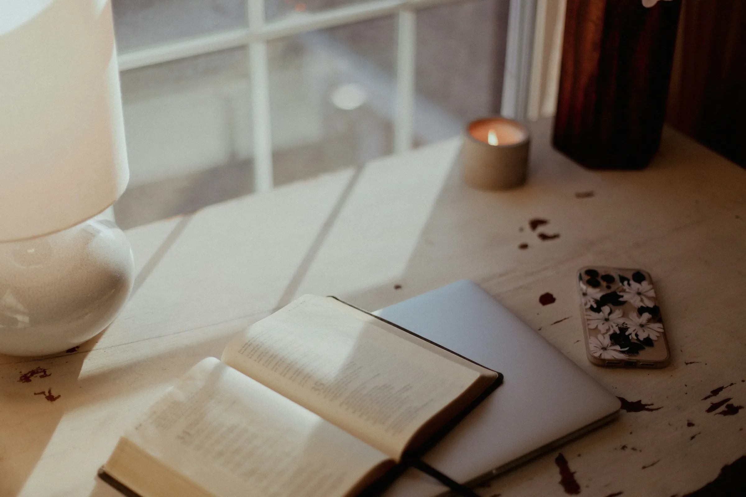 A quiet desk in morning light with an open notebook